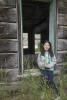 Claira Sitting In Log Home Window