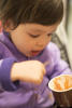 Claira Eating Chocolate Ice Cream From A Cup