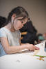 Claira Shaping Stones With Sandpaper