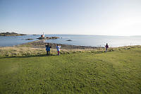 Grass Field Overlooking Lighthouse