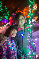 Nara And Claira Around String Of Lights