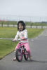 Claira Biking With Her Tongue Out