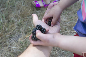 Claira Taking Handfull Of Blackberries