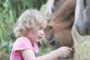 Kaylee Feeding Pony Grass