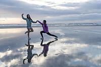 Kids Dancing On Wet Sand