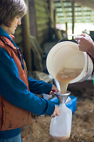 Apple Juice Funneled Into Container