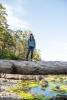 Nara Standing On Bridge Log