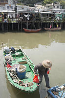 Fisherman Walking From One Boat To Another