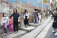 Stacked Birdcages Overrun With Tourists