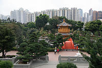 Orange Bridge With Tall Buildings Behind