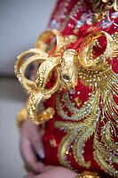 Gold Bangles On Embroidered Fabric