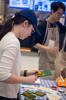 Nara Spreading Paint On Stamp