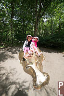 Girls Playing On Hippo Statue