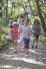 Four Kids Running Down Trail