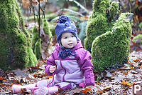 Nara Sitting In Moss And Leaves