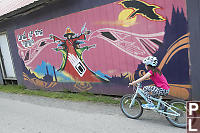 Claira Biking Past Mural