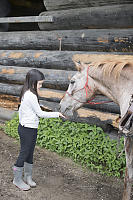 Claira Feeding Her Horse